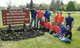 American Profit Recovery employees wearing t-shirts and jeans and posing next to Island Lake Recreation Area sign [Image by creator  from ]